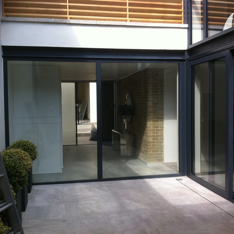 Floor-to-ceiling sliding doors opening to courtyard in East Sheen